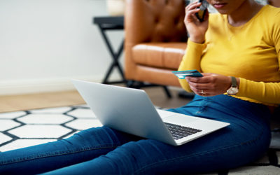 girl on laptop using credit card