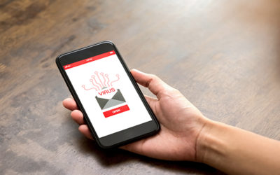 hand holding phone with virus pop up on screen