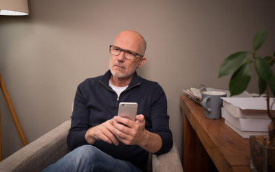 man pondering with a cell phone in hadn